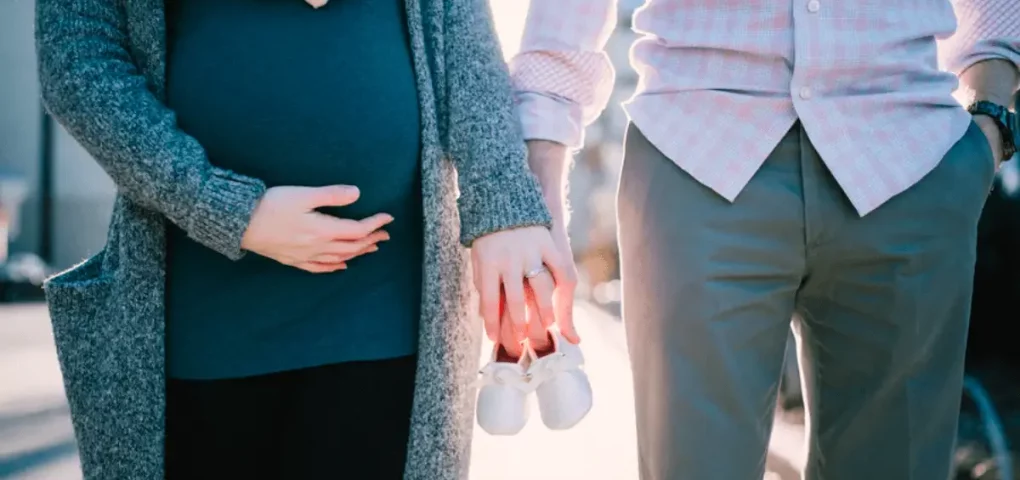 pregnant woman and husband holdings hands